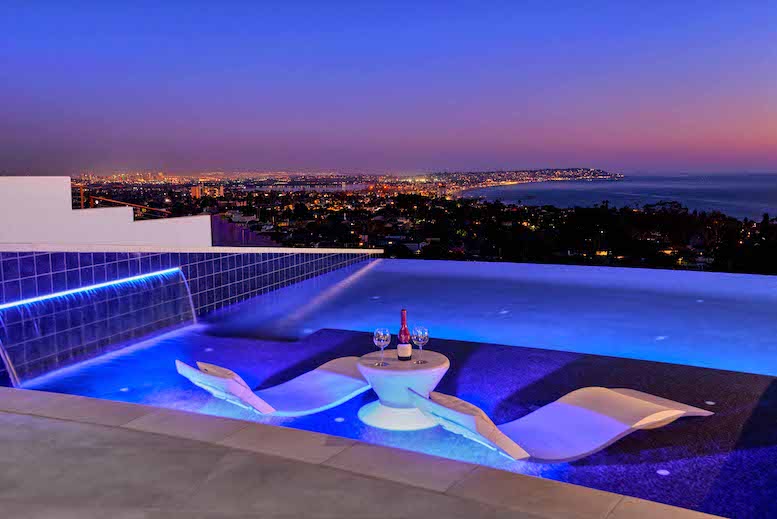 Sun Deck Zero edge pool at night overlooking the city and ocean